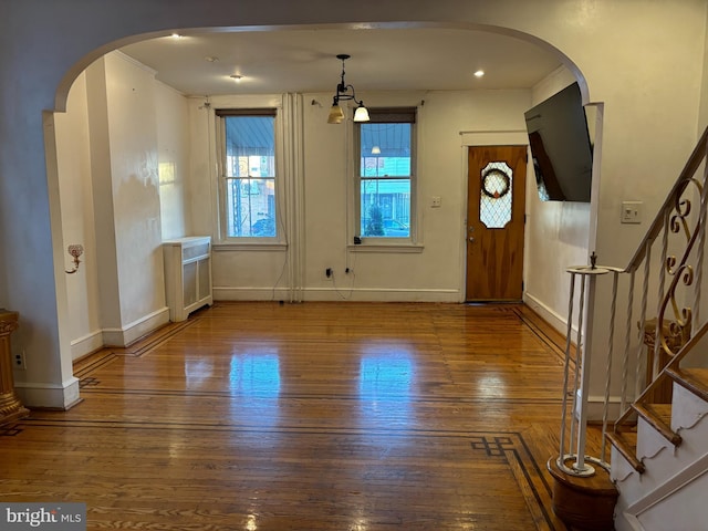 entryway featuring radiator heating unit, hardwood / wood-style flooring, and ornamental molding