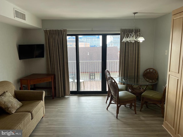 interior space featuring wood-type flooring and an inviting chandelier