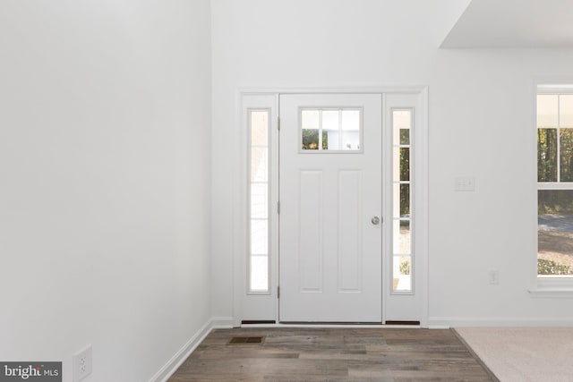 entryway with dark hardwood / wood-style flooring