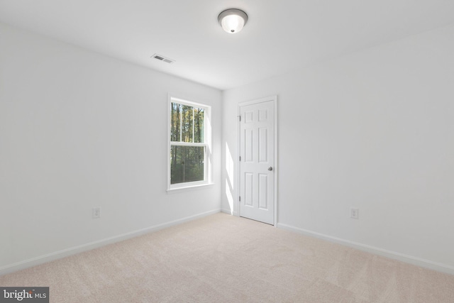 unfurnished room with light colored carpet