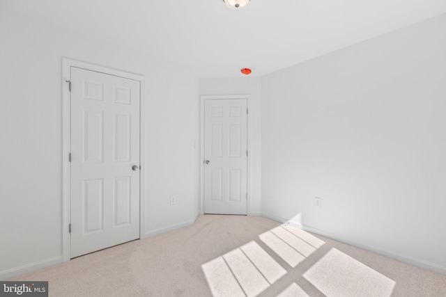 unfurnished bedroom featuring light carpet