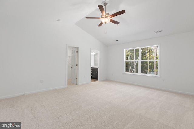 unfurnished living room with ceiling fan, light carpet, and vaulted ceiling