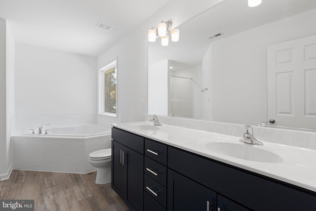 full bathroom featuring wood-type flooring, vanity, toilet, and separate shower and tub