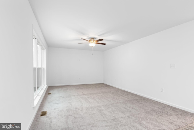 unfurnished room featuring light carpet and ceiling fan