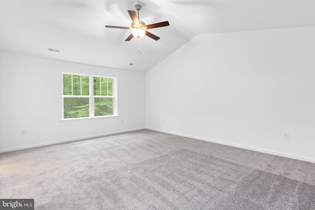 unfurnished room featuring carpet flooring, ceiling fan, and vaulted ceiling