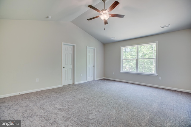 unfurnished room with carpet, ceiling fan, and vaulted ceiling