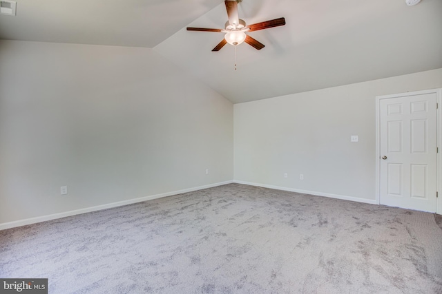 carpeted empty room featuring ceiling fan and lofted ceiling