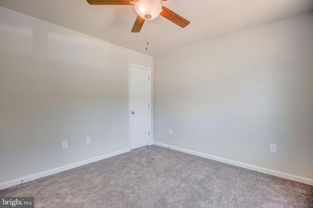 carpeted spare room featuring ceiling fan