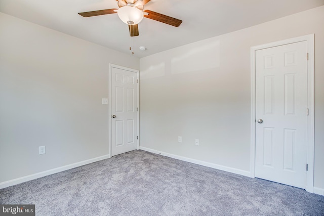 unfurnished room with light colored carpet and ceiling fan