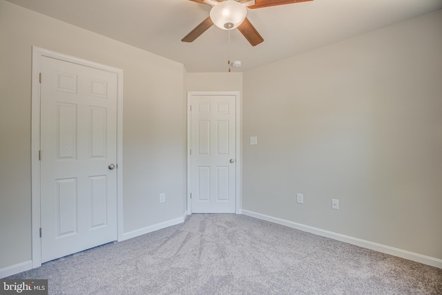 interior space with light colored carpet and ceiling fan