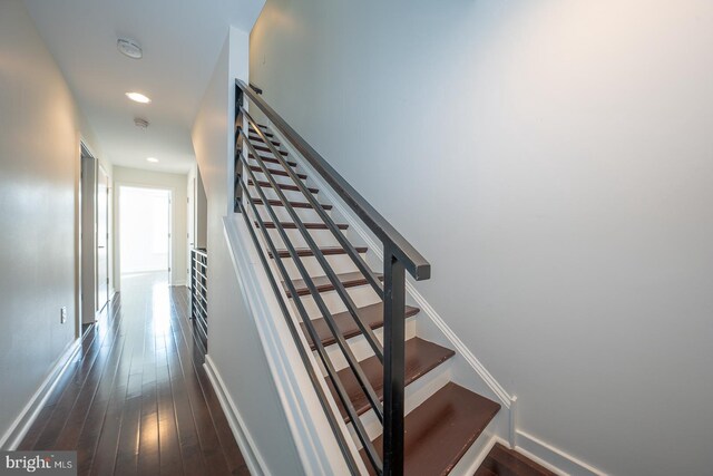 staircase with hardwood / wood-style flooring