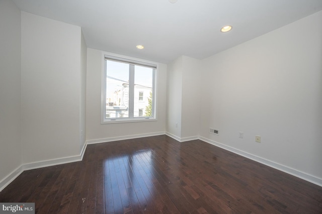 empty room with dark wood-type flooring