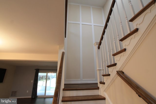 staircase with hardwood / wood-style flooring