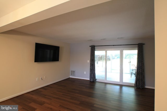 empty room with dark wood-type flooring