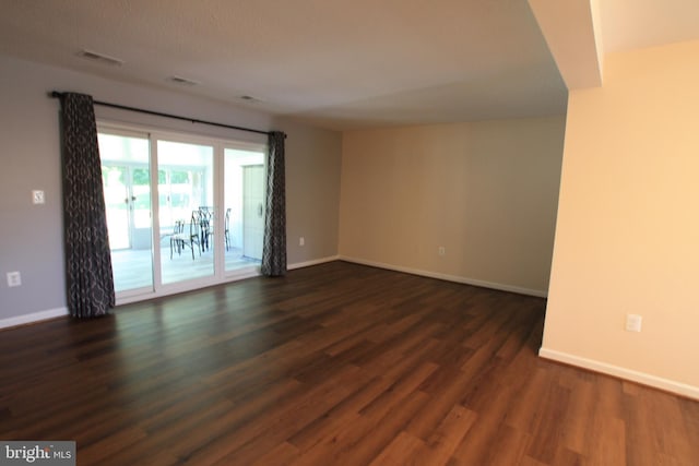 unfurnished room featuring dark hardwood / wood-style flooring