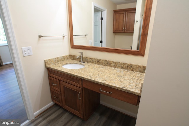 bathroom with hardwood / wood-style flooring and vanity