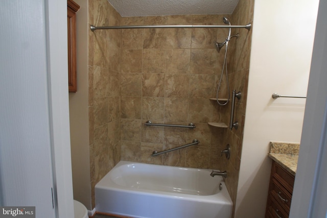 full bathroom with a textured ceiling, vanity, toilet, and tiled shower / bath