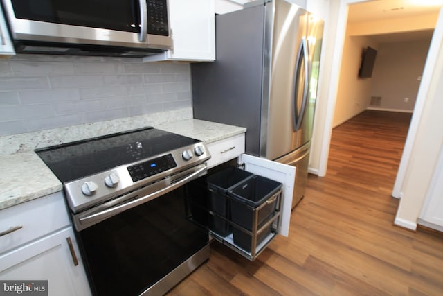 kitchen featuring light stone countertops, white cabinetry, and stainless steel appliances