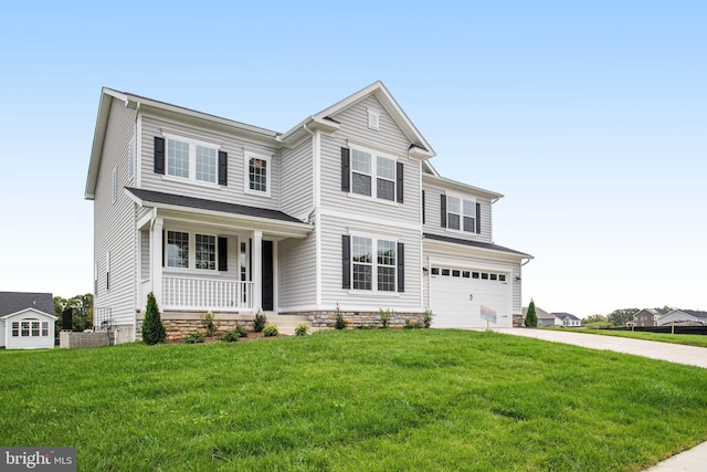 view of property featuring a porch, a garage, and a front yard