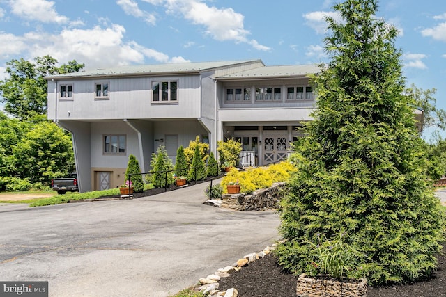 view of front of house featuring a balcony