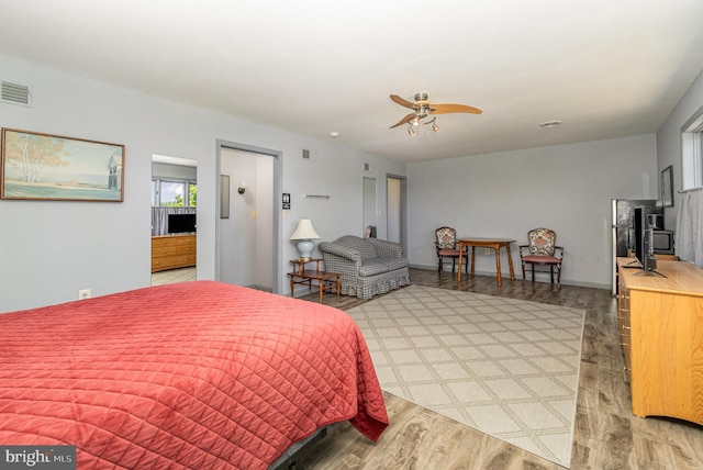 bedroom with ceiling fan and hardwood / wood-style flooring