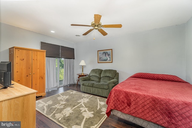 bedroom with dark hardwood / wood-style floors and ceiling fan