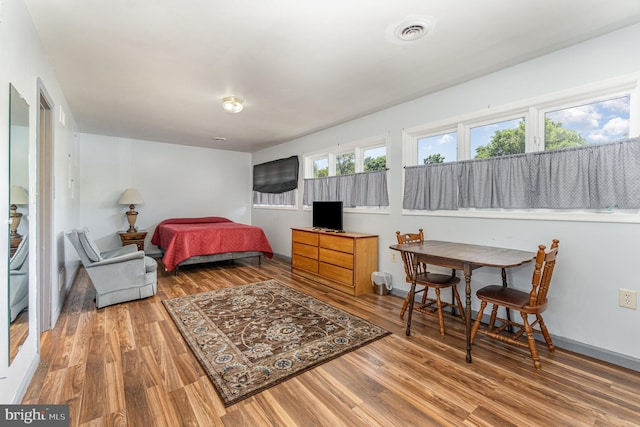 bedroom with hardwood / wood-style flooring