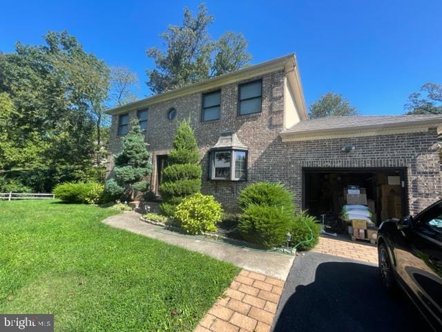 view of front of home with a garage and a front lawn