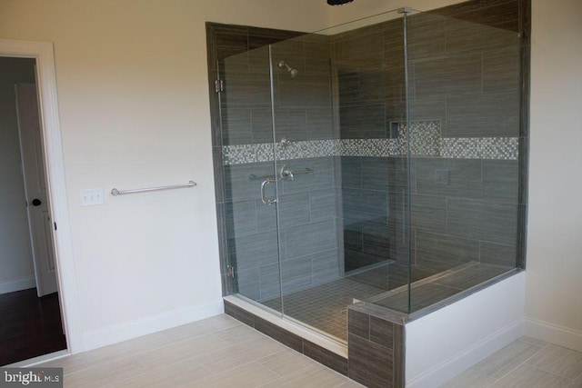 bathroom featuring tile patterned flooring and a shower with door