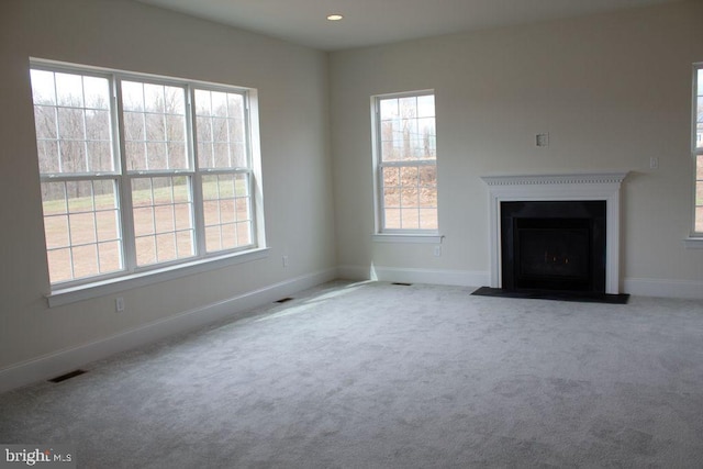 unfurnished living room featuring light carpet