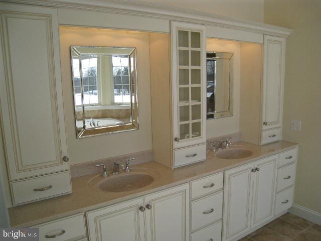 bathroom with tile patterned flooring and vanity