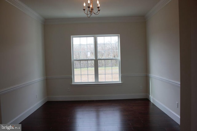 unfurnished room with dark hardwood / wood-style floors, crown molding, and a notable chandelier