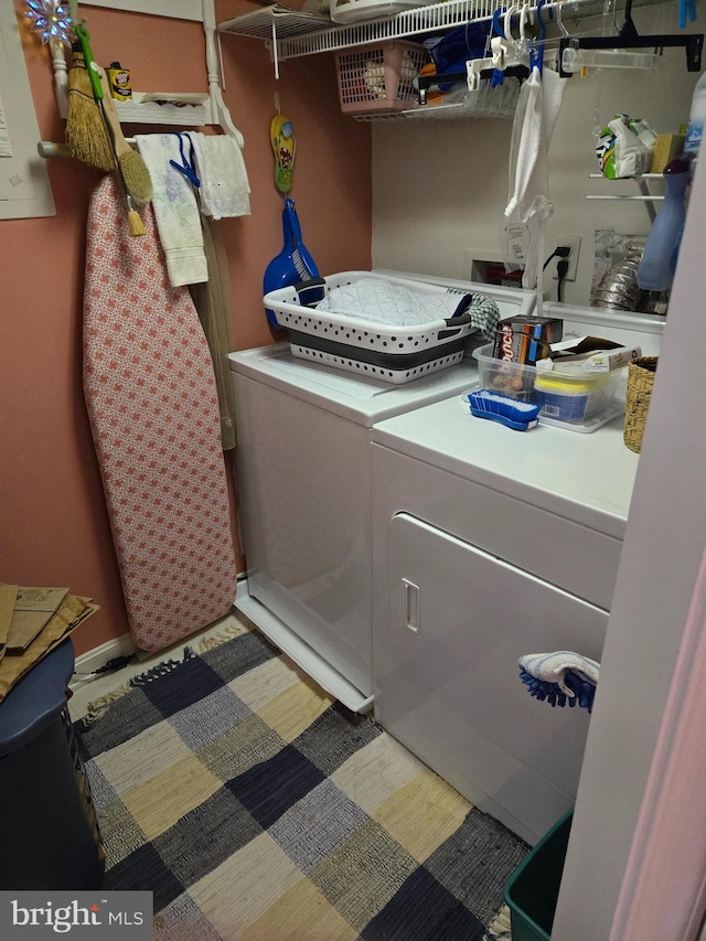 clothes washing area featuring washing machine and clothes dryer