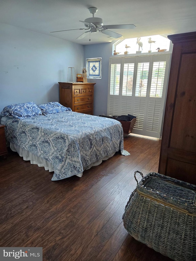 bedroom featuring dark hardwood / wood-style floors, ceiling fan, and pool table