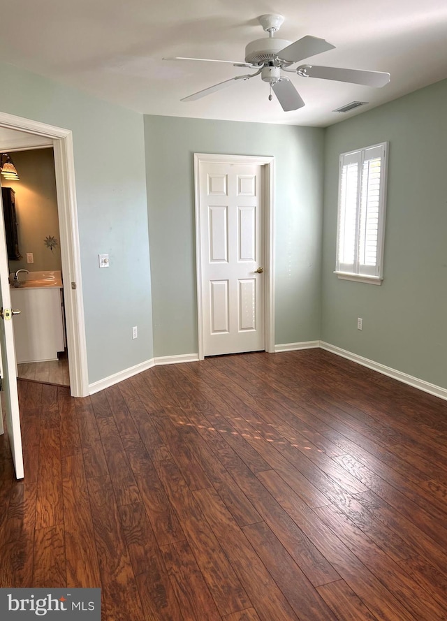 unfurnished bedroom with ceiling fan and dark hardwood / wood-style floors