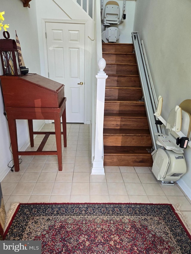 stairway featuring tile patterned flooring