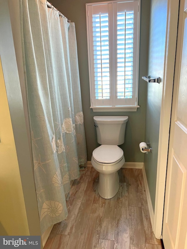 bathroom featuring wood-type flooring and toilet