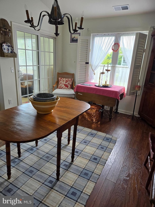 dining room with a chandelier, wood-type flooring, and billiards