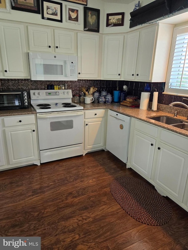 kitchen featuring white cabinets, white appliances, dark wood-type flooring, and sink