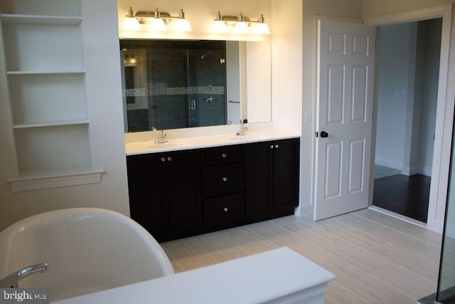 bathroom featuring vanity and a bath