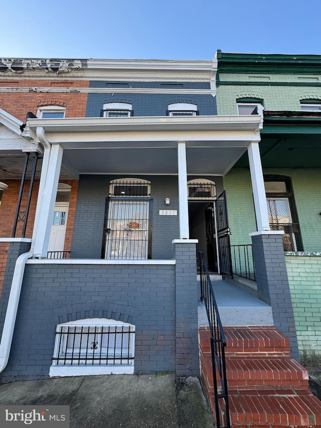 view of exterior entry featuring covered porch