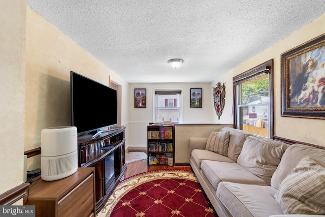 carpeted living room featuring a textured ceiling