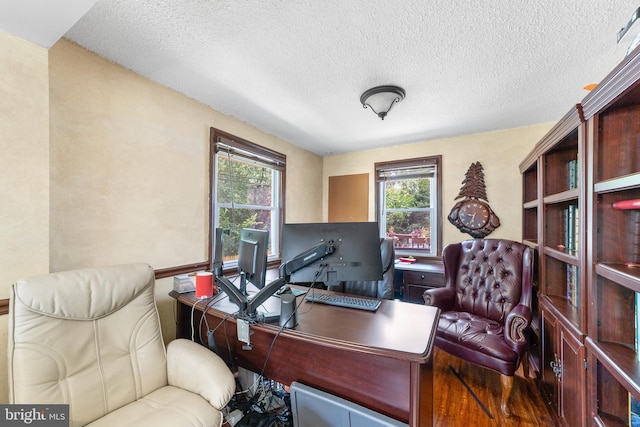 office featuring hardwood / wood-style floors, a textured ceiling, and plenty of natural light