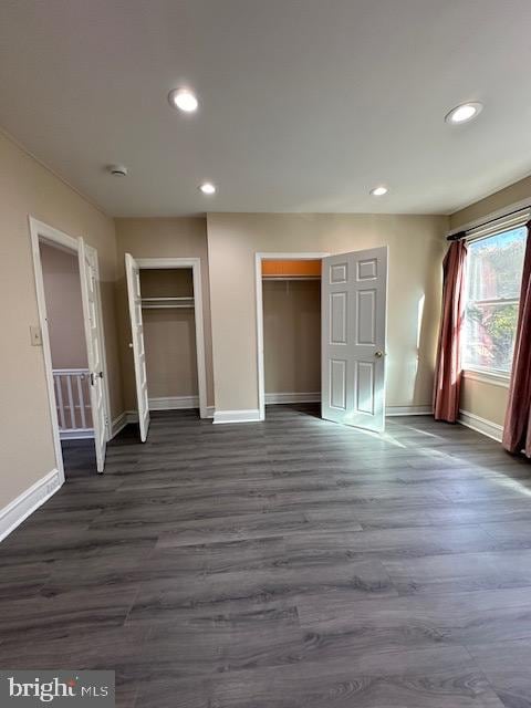 unfurnished bedroom featuring dark hardwood / wood-style flooring