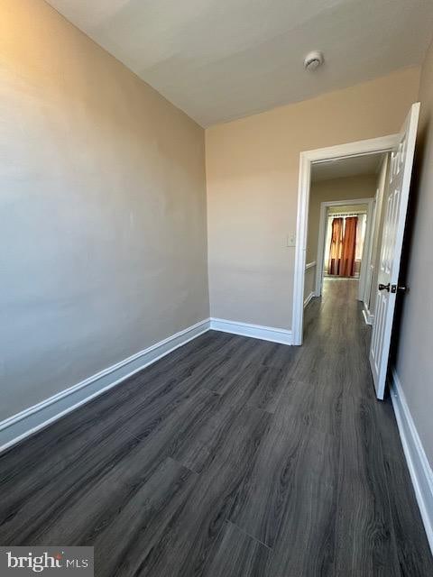 empty room with dark hardwood / wood-style floors