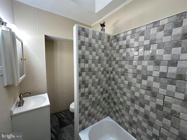 full bathroom featuring vanity, toilet, and tiled shower / bath