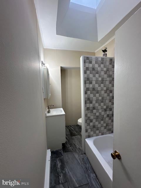 full bathroom with vanity, toilet, ornamental molding, and shower with separate bathtub