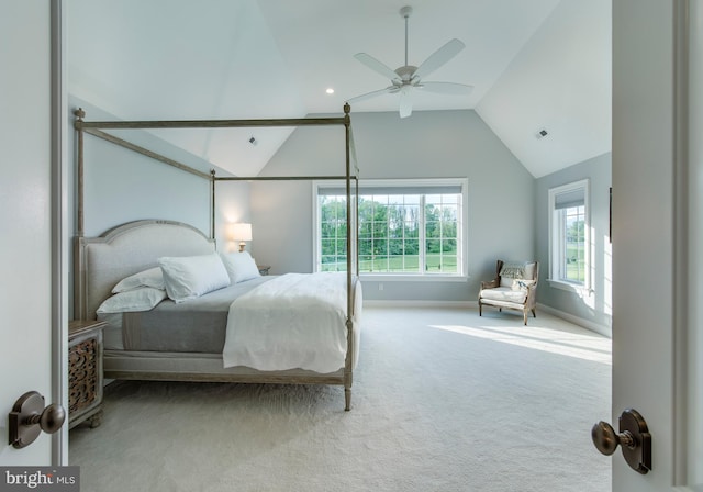 bedroom with ceiling fan, light colored carpet, and vaulted ceiling