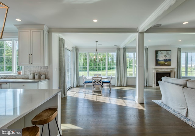 dining room featuring light hardwood / wood-style floors, crown molding, and a premium fireplace