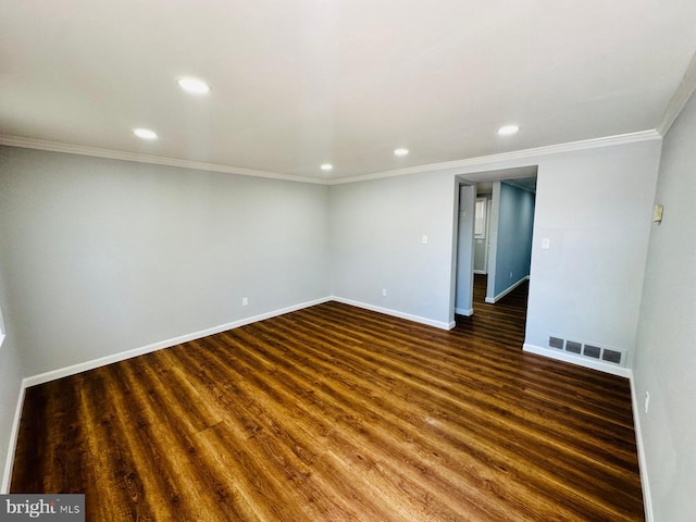 empty room featuring dark hardwood / wood-style flooring and crown molding